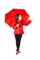 girl dressed in raincoat holding umbrella over white