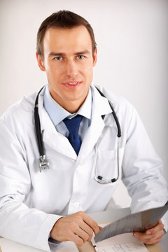 A male doctor examining x-ray