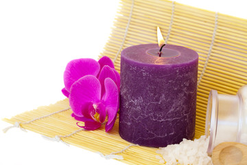 candle on mat with sea salt and flowers