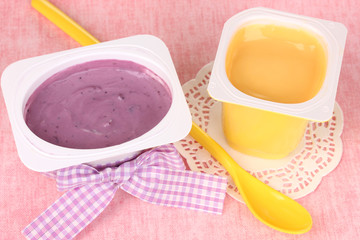 Yogurts with banana and blueberries close-up