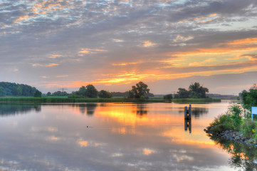 Fototapeta na wymiar Summer sunrise over a small lake