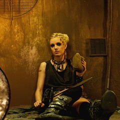 Tired woman with a spear in a bunker