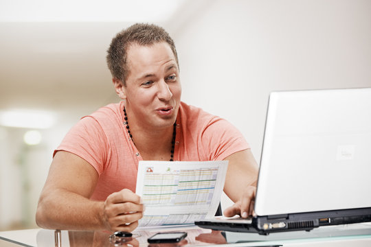 office employee with data sheet at the laptop