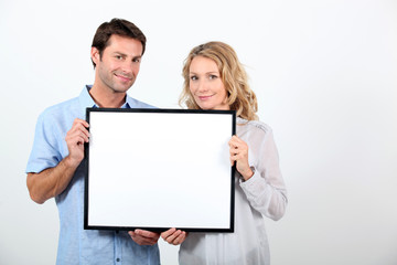 couple holding frame