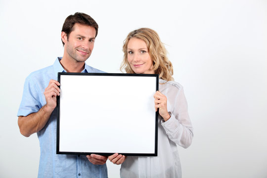 Couple Holding Frame