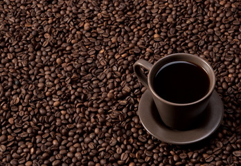 Coffee cup on coffee beans