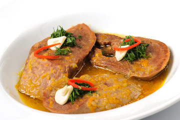 Stewed slices of beef tongue with sauce and seasoning