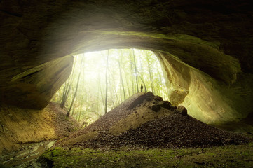 cave entrance with man and light