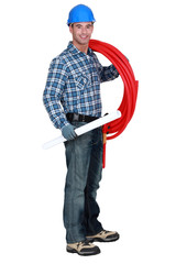 handsome plumber carrying red hose isolated on white