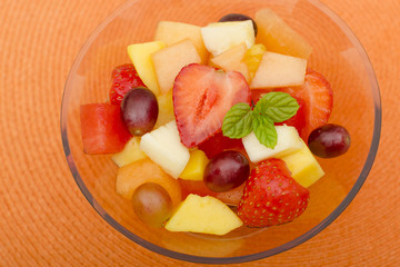 Fruit Salad - A colourful variety of fruit in a glass bowl.