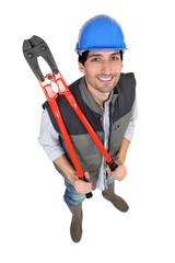 Construction worker holding large pliers