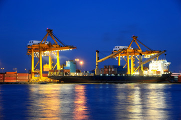 Fototapeta na wymiar Container Cargo freight ship with working crane bridge in shipya