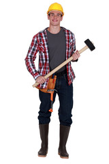 Young construction worker holding sledge-hammer