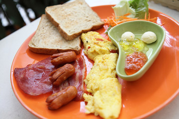Breakfast with ham , fried egg and bread