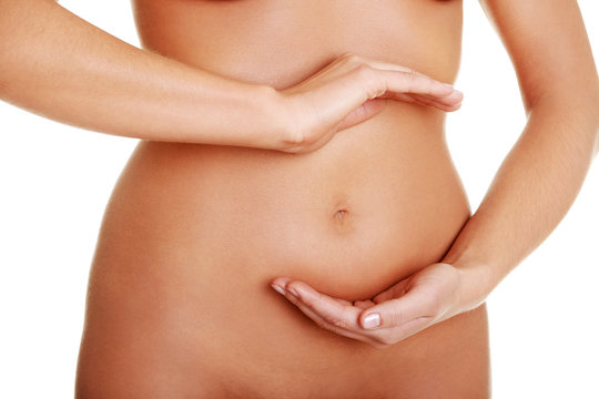 Fit young woman belly with hand on it