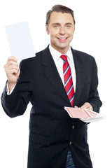 Executive showing blank playing card to camera