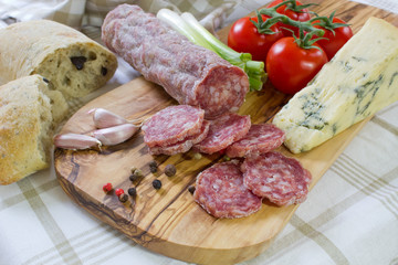 French saucisson with  cheese on cutting board