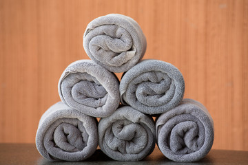 Obraz na płótnie Canvas Rolled up grey spa towels