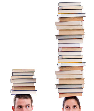 Man and woman holding books on their heads