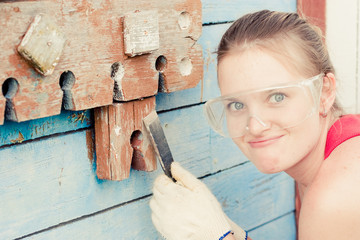 	Young woman making cosmetic alterations of house