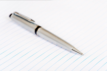 Elegant silver pen on lined note paper