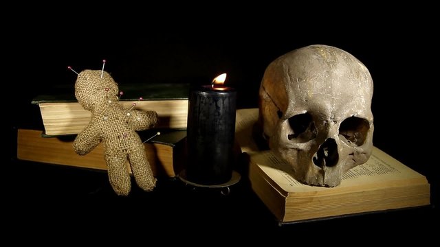 Human skull and voodoo doll