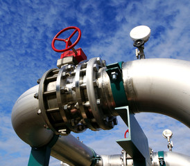 Industrial zone, Steel pipelines and valves against blue sky