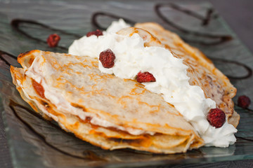 Cottage cheese pancake with aronia fruits and whipped cream