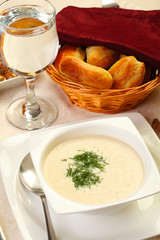 Cream soup with bread and water glass