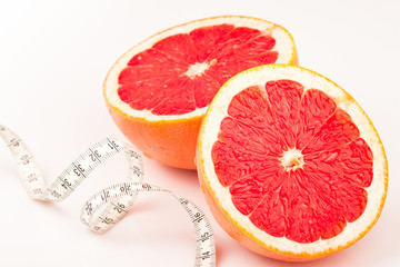 Measure tape and two healthy grapefruit halves