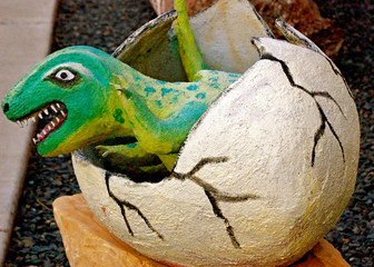 Dinosaur hatching out of egg