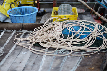 Rope on wooden floor of the fisherman boat.