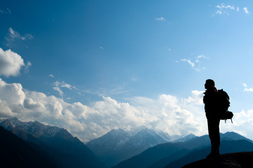 Climbing young adult at the top of summit