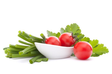 Spring onions and cherry tomato in bowl