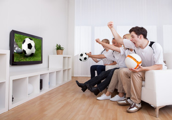 Jubilant family watching television