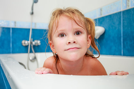 Cute four year old girl taking a relaxing bath