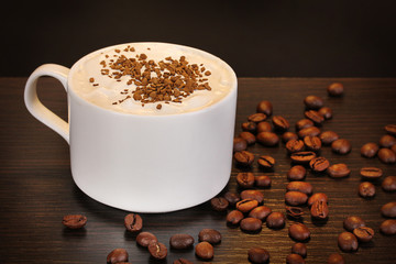 Latte on wooden table on brown background