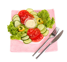 Chopped vegetables and sauce on plate isolated on white