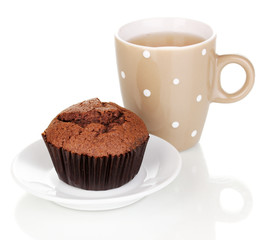 Fresh muffin with tea isolated on white