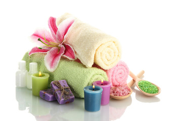 Obraz na płótnie Canvas towels with lily, aroma oil, candles, soap and sea salt