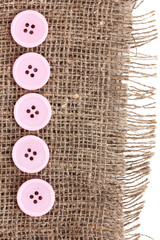 Colorful sewing buttons on sackcloth