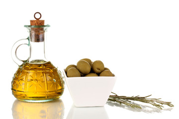 Green olives in white bowl with rosemary and olive oil isolated