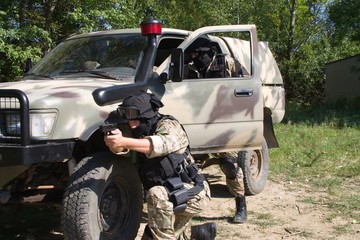 The officer pointing a weapon