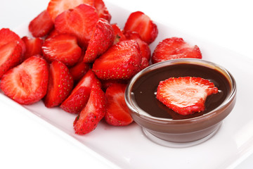 Fresh strawberries on plate with chocolate close-up