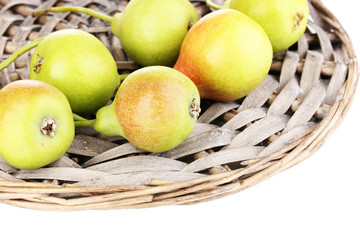 ripe pears on wicker mat isolated on white.