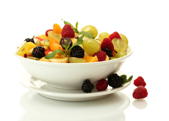 fresh fruits salad in bowl  and berries, isolated on white