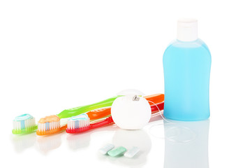 Toothbrush, chewing gum and dental floss isolated on white
