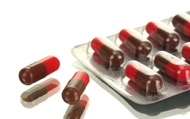 Capsules packed in blisters, isolated on white