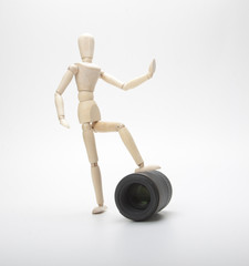 Wooden mannequin and photo lens