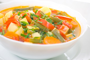 Fresh vegetable soup made of green bean, carrot, potato, red bel
